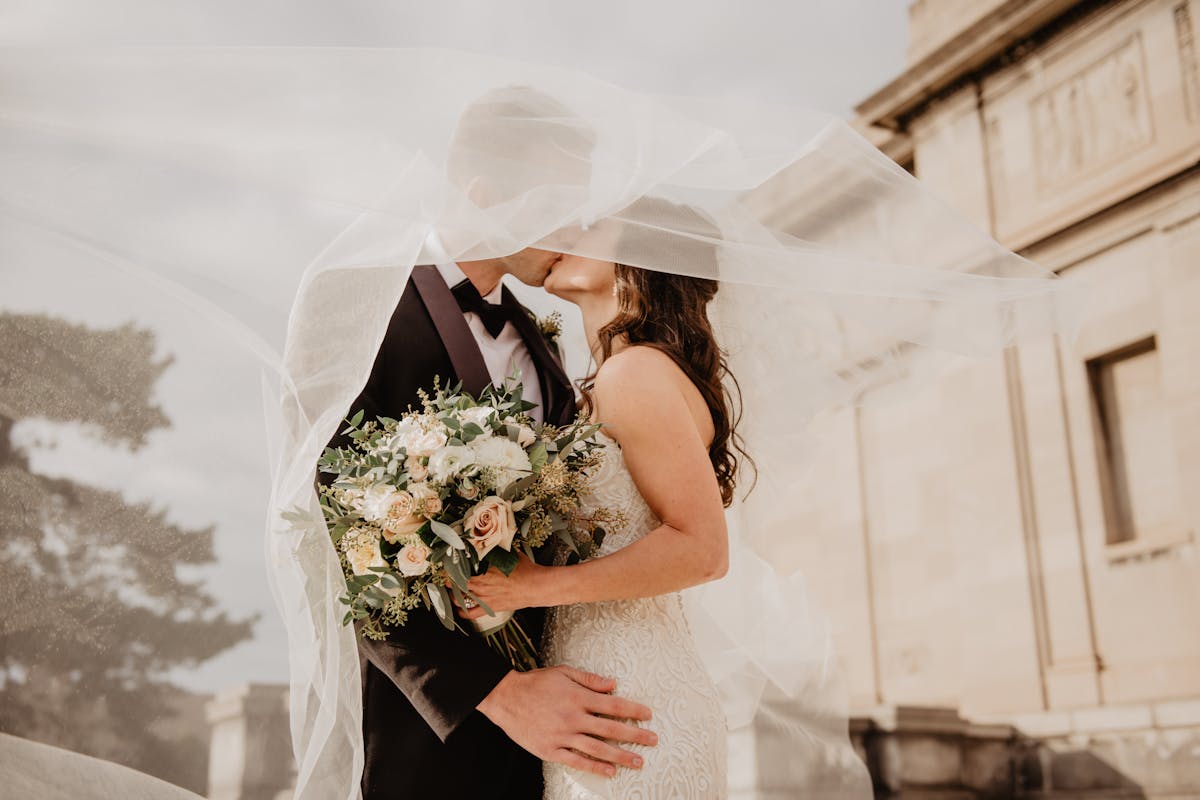 Friends wedding theme - couple kissing, bride veil, building
