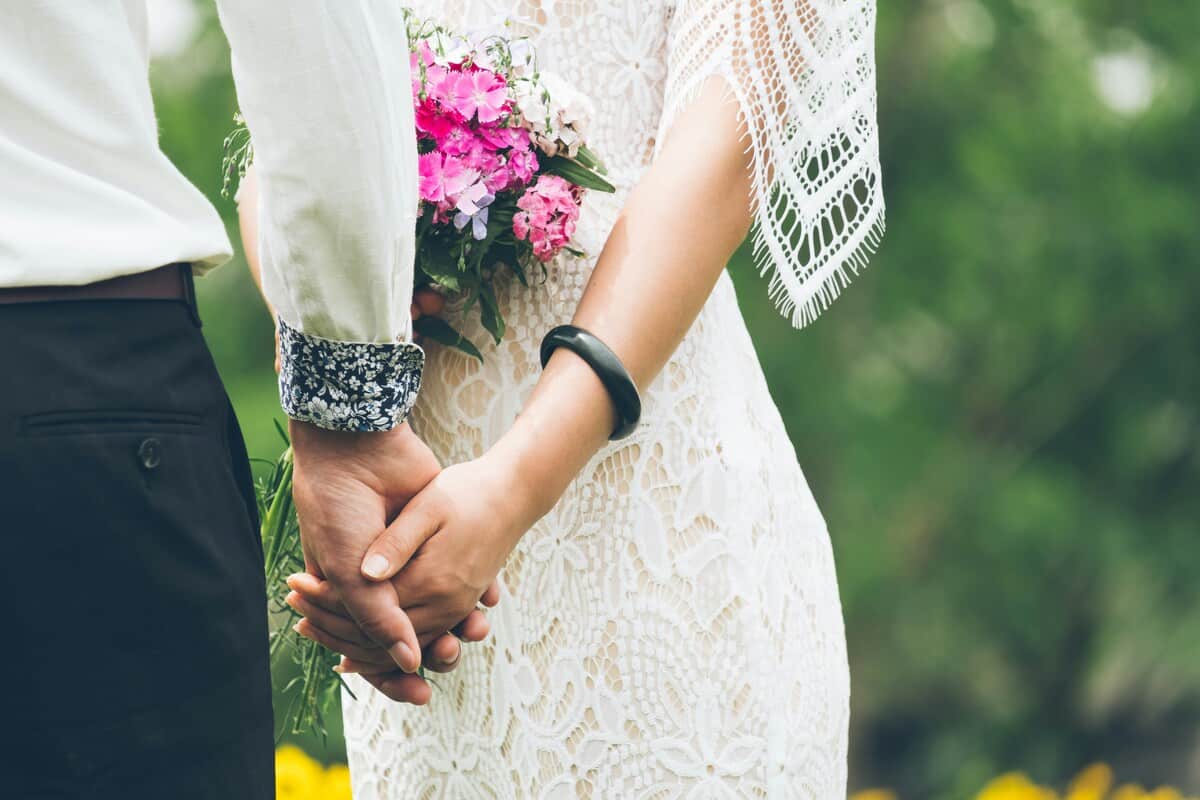 Peaky-Blinders-wedding-theme-the-main-reasons-why-you-should-consider-including-such-a-theme-into-your-event_bride-and-groom-holding-hands.