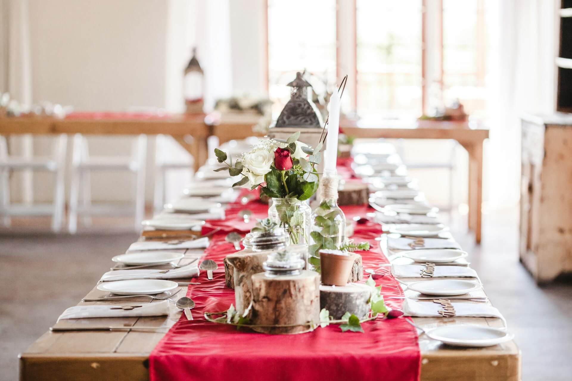 Gold and red wedding decor - table, red rose, white chairs