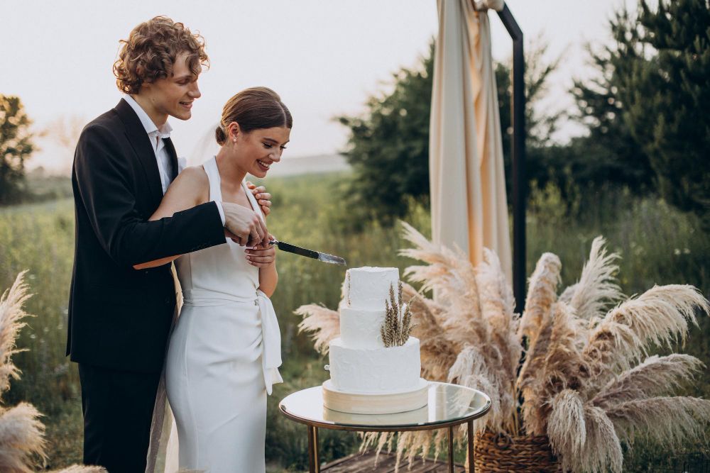 Wedding-art-deco-small-white-wedding-cake-being-cut